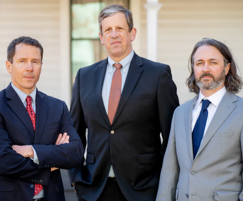 Three of the Silver & Archibald disability attorneys, Patrick Cates, Michael Keene and Ben Walters, stand outside their Athens, GA, law office.